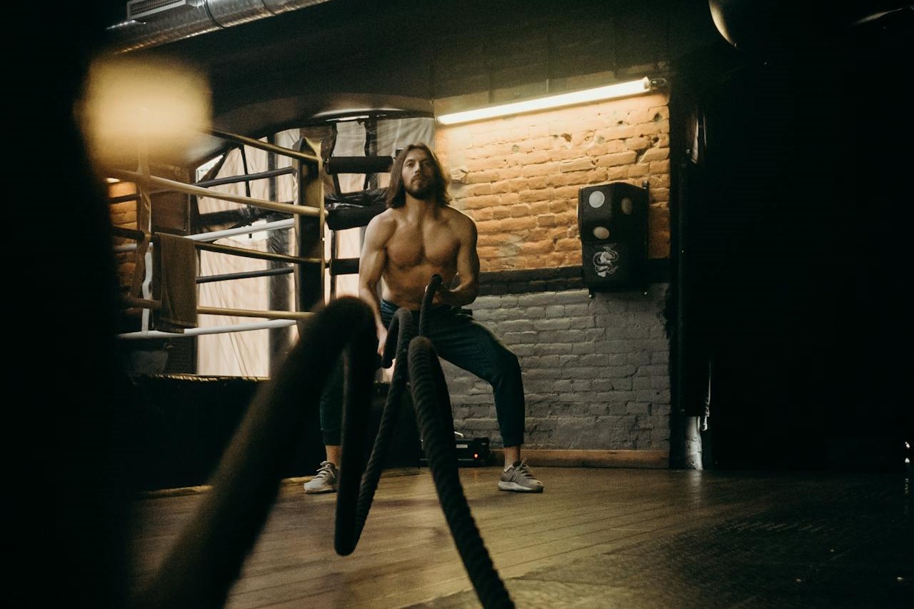 Photo by cottonbro studio: https://www.pexels.com/photo/man-in-black-pants-and-black-tank-top-standing-on-brown-wooden-floor-4752861/