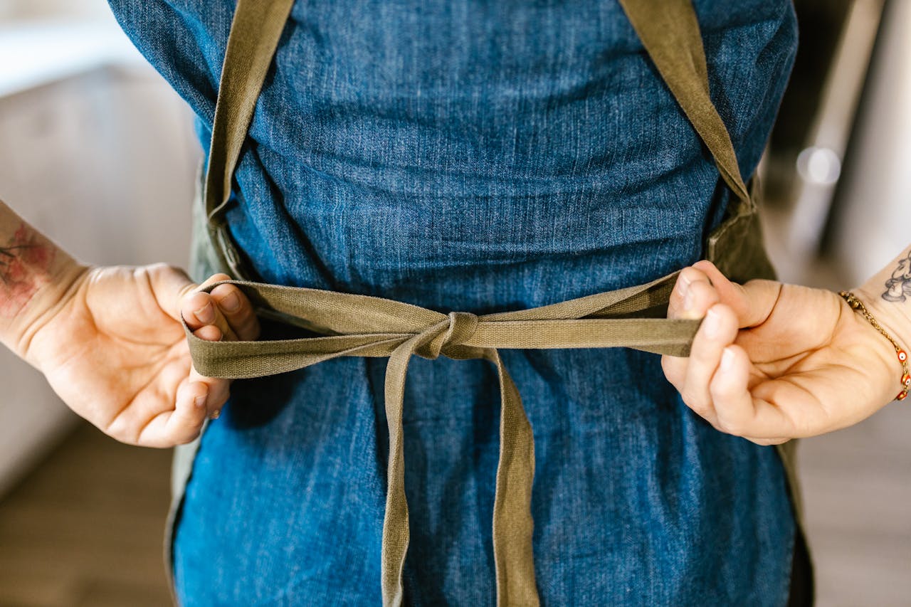 Photo by RDNE Stock project: https://www.pexels.com/photo/woman-tying-up-apron-10432739/
